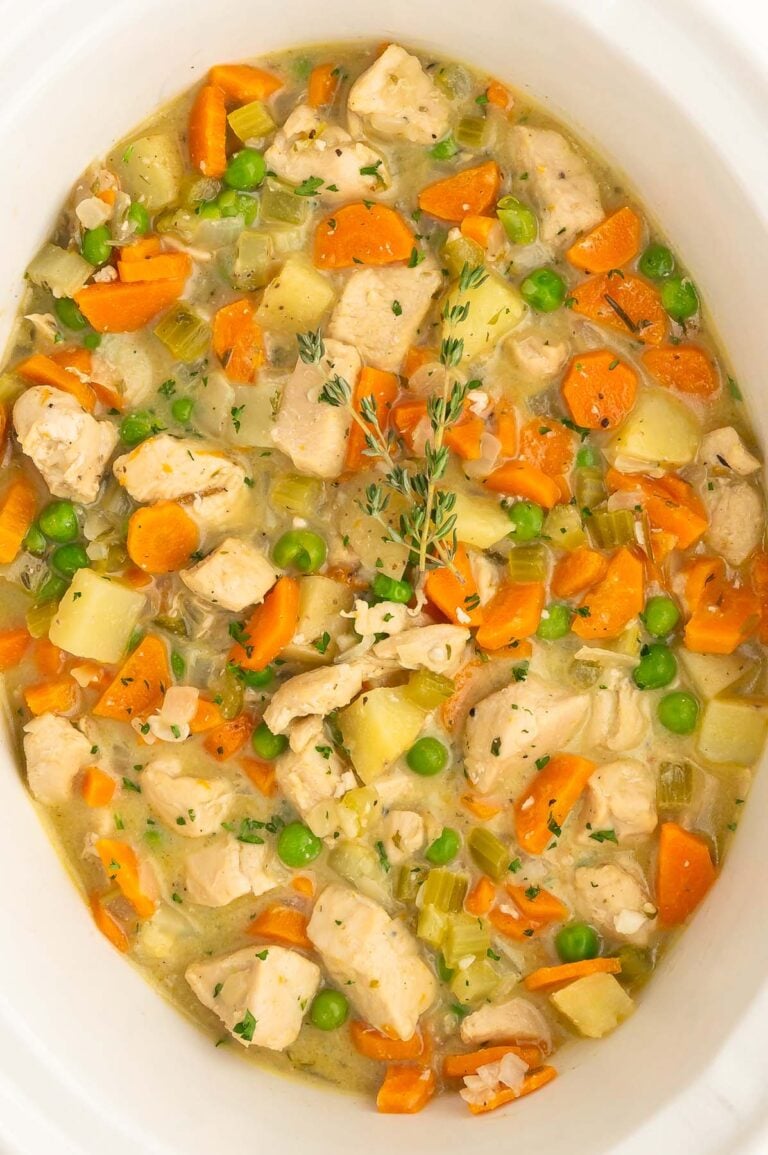 a close up of slow cooker chicken stew in a crockpot base