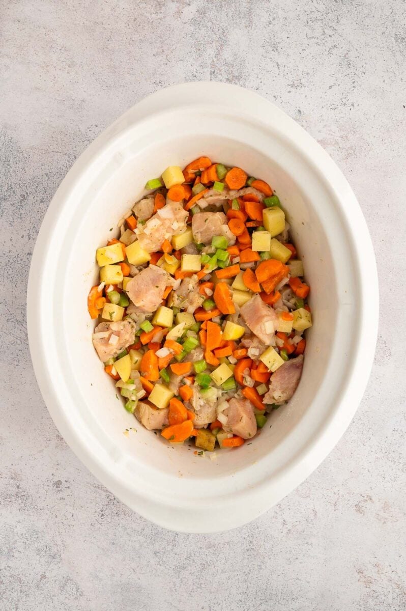 crockpot filled with ingredients for slow cooker chicken stew before being cooked