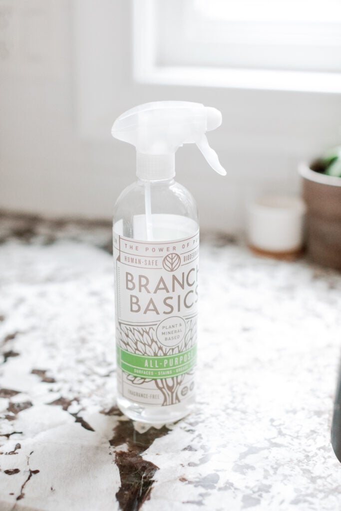 A close up of branch basics bottle on a granite counter top
