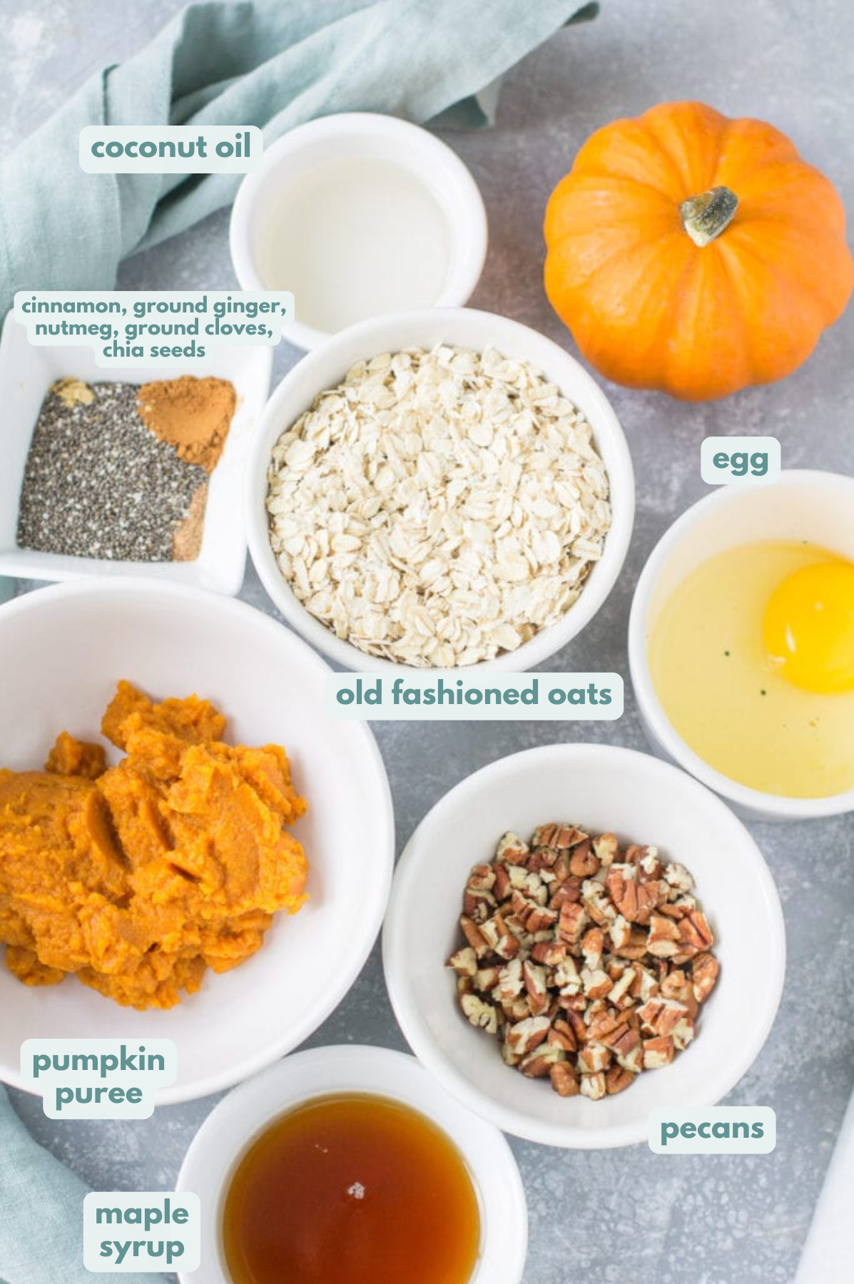 Ingredients for Pumpkin Breakfast Cookies on a grey background in small bowls