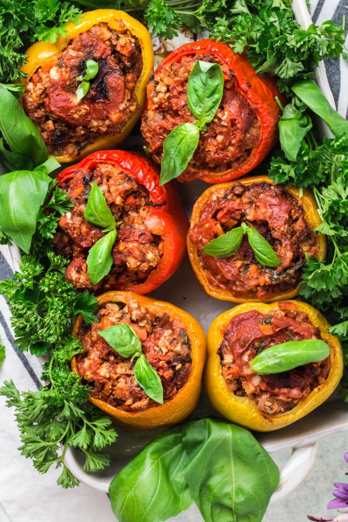 An overhead shot of paleo stuffed peppers fresh out of the oven in a white baking dish
