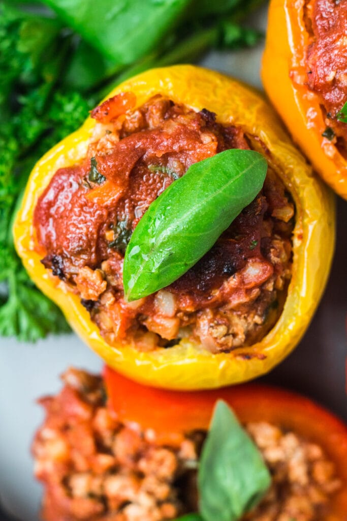 paleo stuffed peppers laying flat on a white plate.