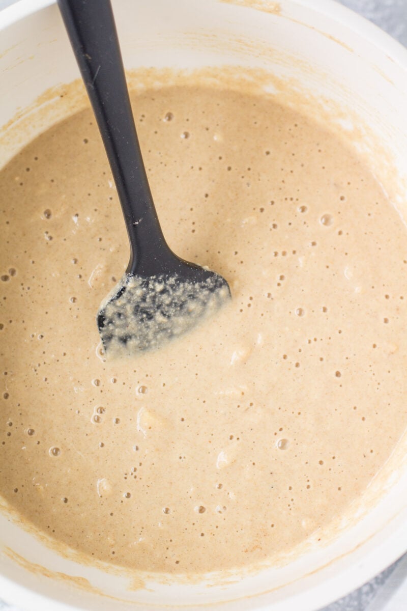 apple cider bread batter in a white bowl