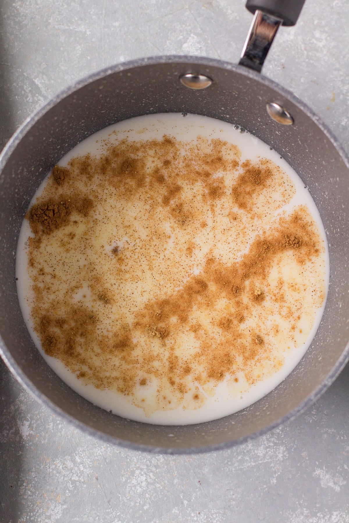 a pot on the stove heating up a gingerbread latte