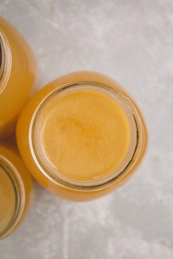 An overhead shot of bone broth in a glass mason jar