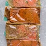 4 Healthy Salmon Marinades in ziploc bags on a grey background