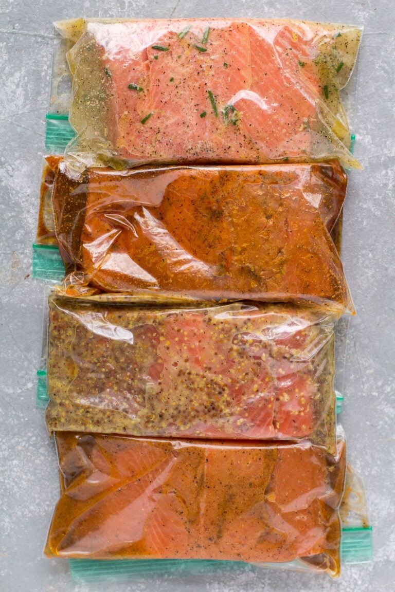 4 Healthy Salmon Marinades in ziploc bags on a grey background