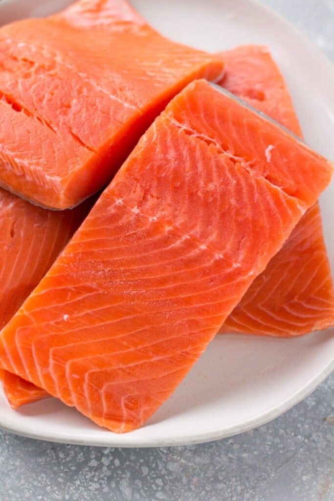 a plate with wild caught salmon piled on it. Whole30, paleo and gluten fere