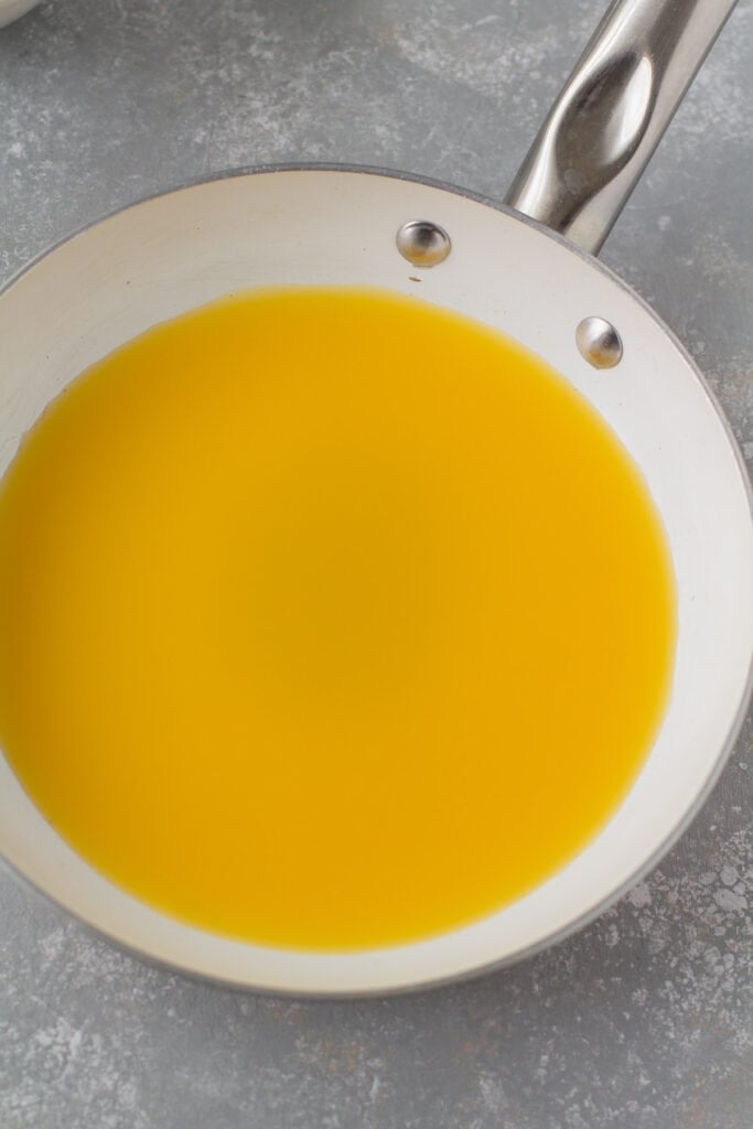 A close up of juice being cooked in a pan for healthy gummy bears