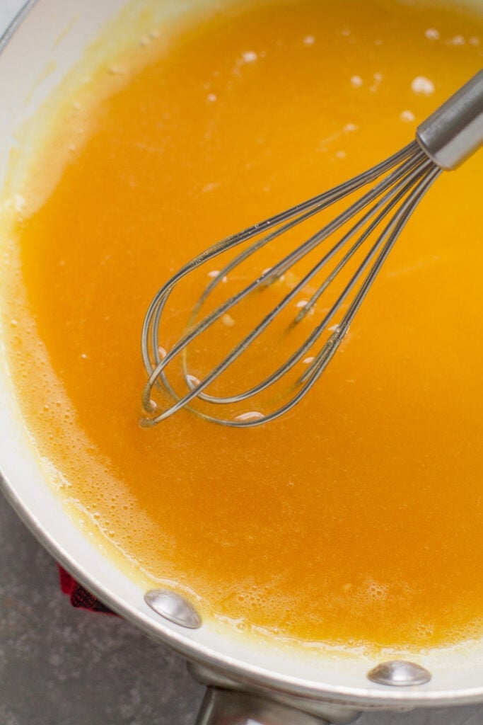 juice and gelatin being whisked together for healthy gummy bears