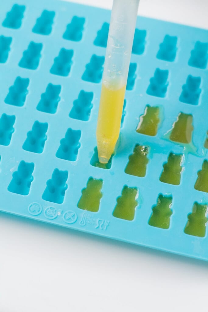 a dropper placing juice into healthy gummy bears