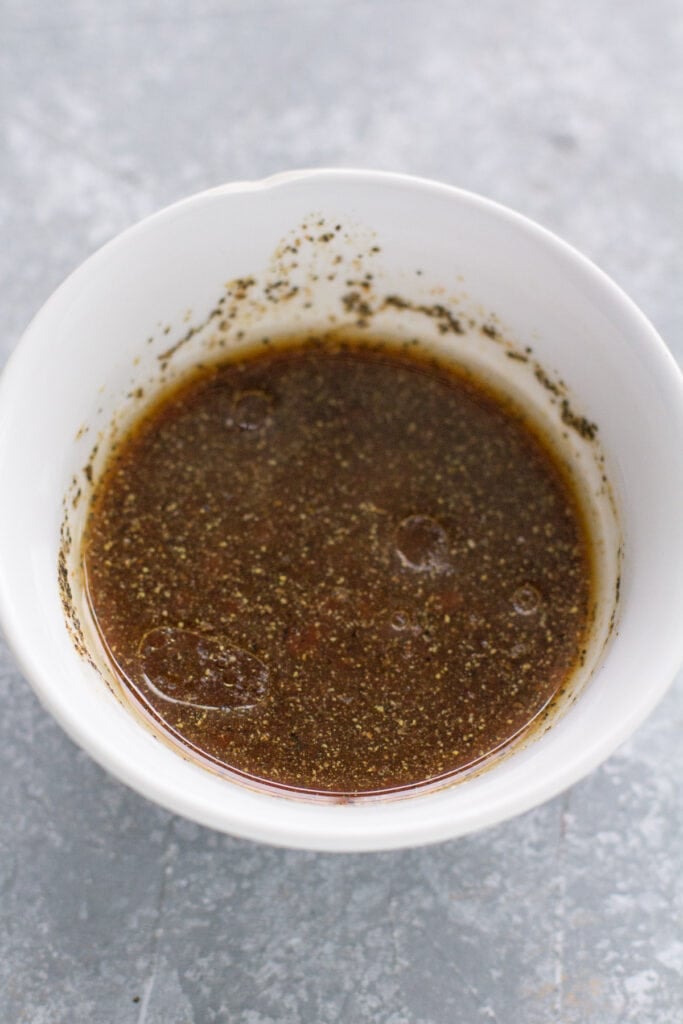 Healthy salmon marinade being mixed together on a grey background