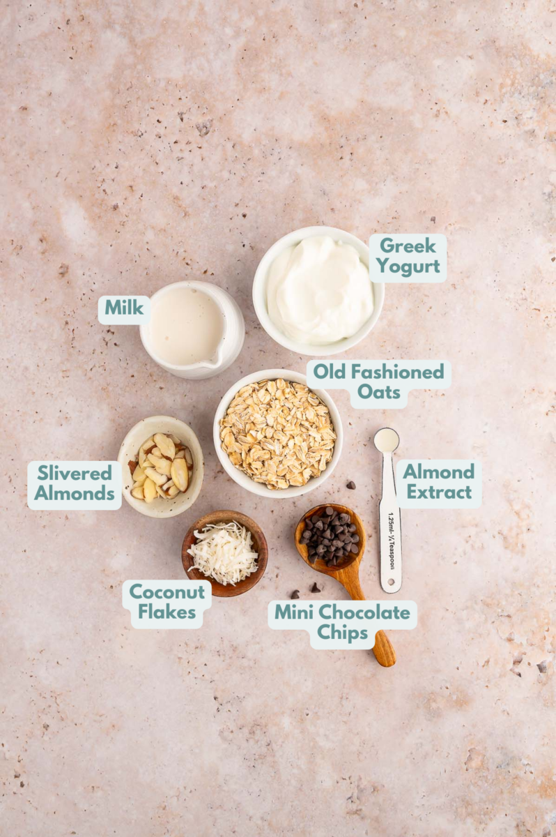 Ingredients of almond joy overnight oats laid out in small white bowls.