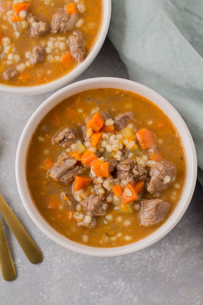 Healthy Beef Barley Soup in two bowls. a healthy soup everyone will love.