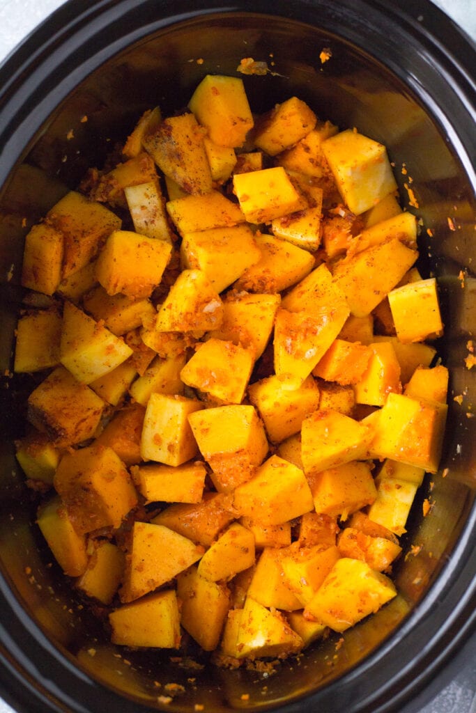 A close up of butternut squash soup in the crockpot before being cooked