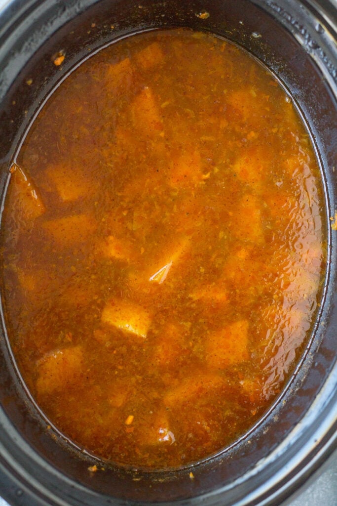 Butternut squash soup in a crockpot after being cooked before being blended