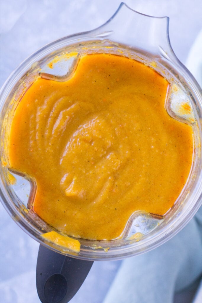 butternut squash soup being blended in a blender