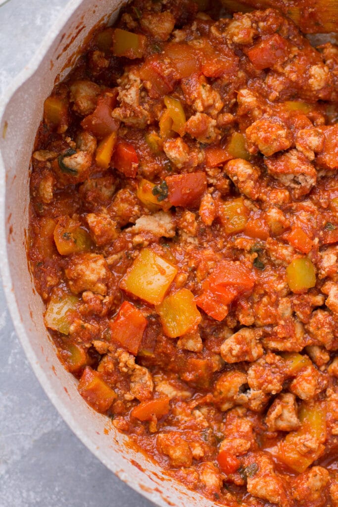 unstuffed pepper bowls being sauteed in a grey pan