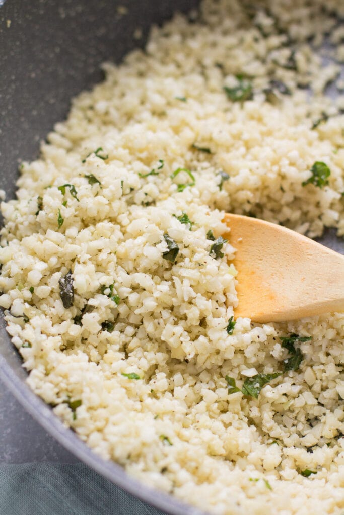 cauliflower rice for stuffed pepper bowls in a grey pan