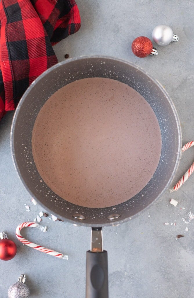 A close up of a peppermint mocha being whisked together on the stove