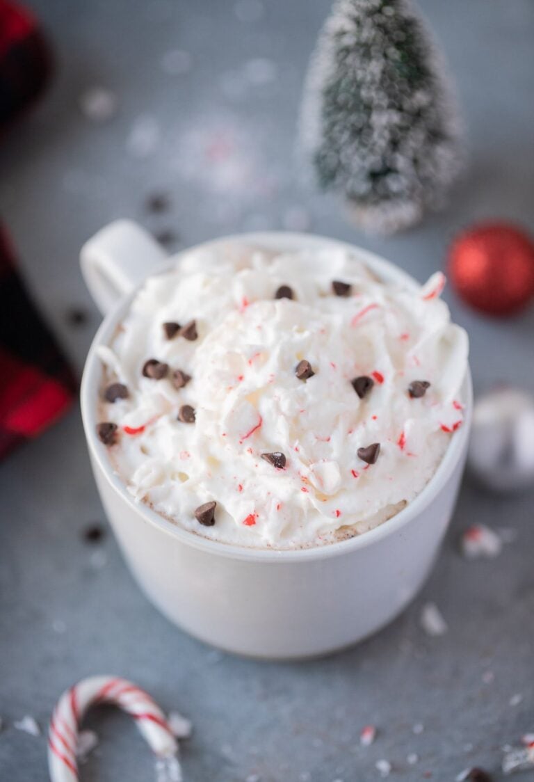 Healthy Peppermint Mocha on a grey background with christmas decor around it.