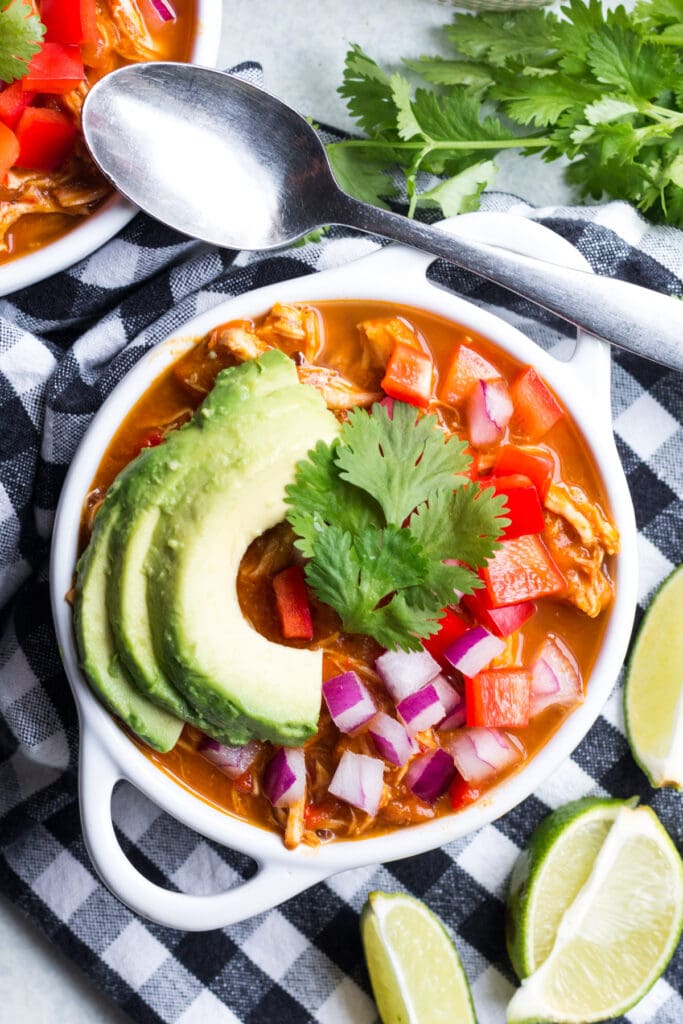 Whole30 Pumpkin Chicken Chili in a small white bowl on a checked linen