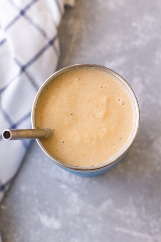 A close up of clementine smoothie in a metal cup from smoothie box