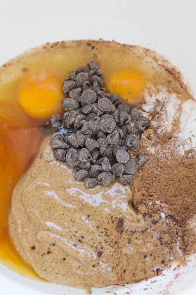 Ingredients for almond butter brownies in a bowl before being mixed together