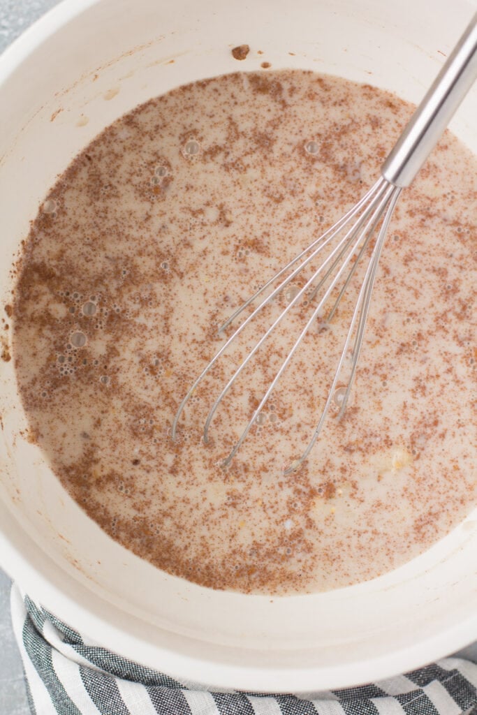 Baked steel cut oatmeal being mixed together in a bowl
