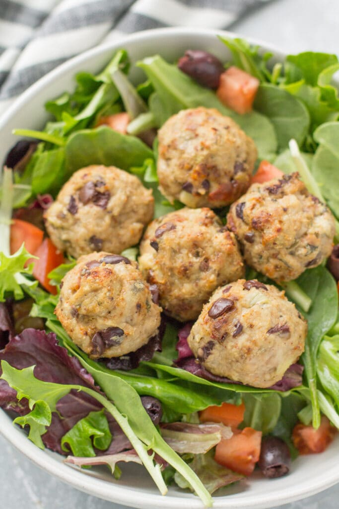 Greek Turkey Meatballs on a bed of spring mix.
