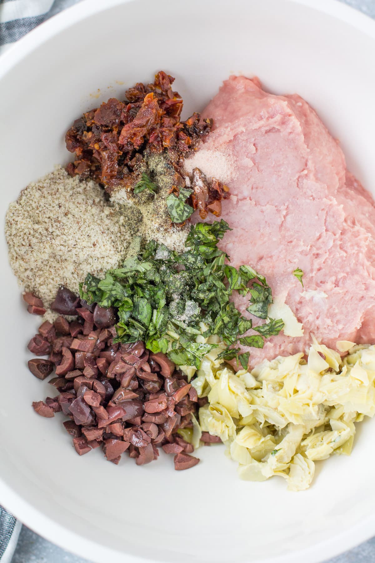 Ingredients for greek turkey meatballs in a white bowl