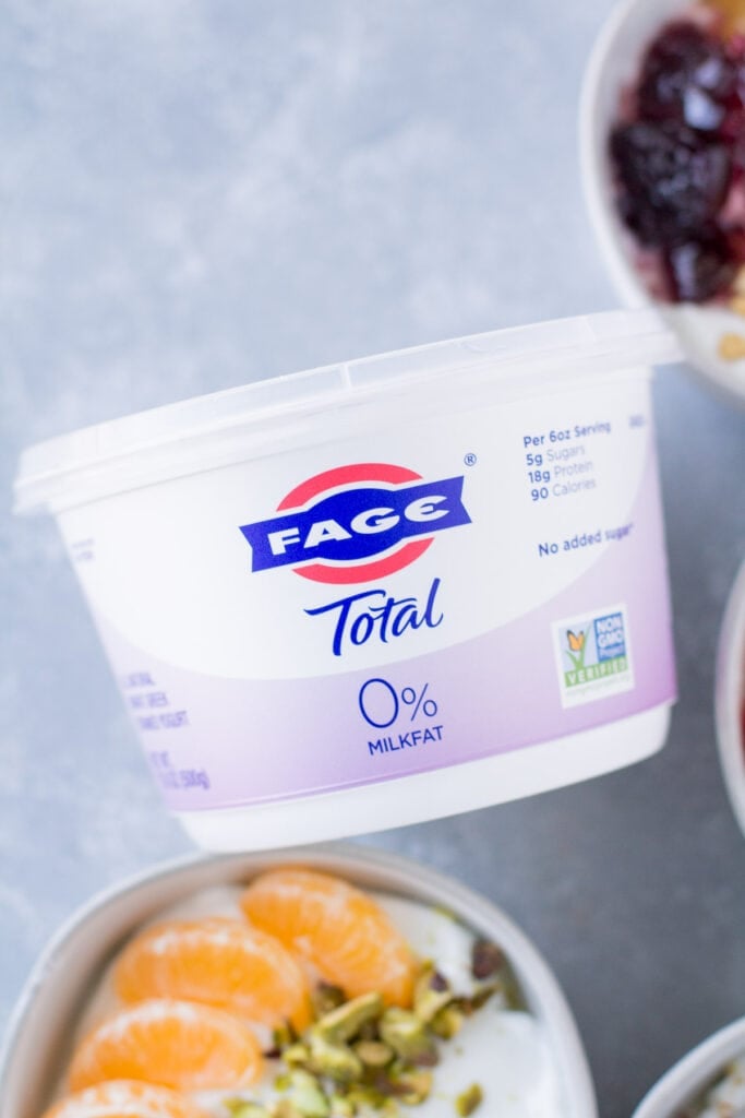 A close up of FAGE Total 0% yogurt on a grey background