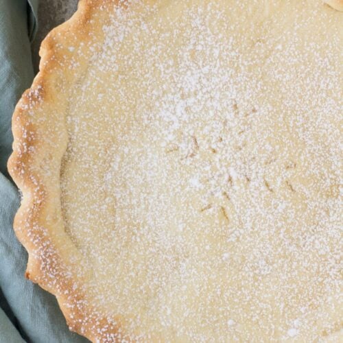 An overhead shot of an Italian Cream Pie on a grey background