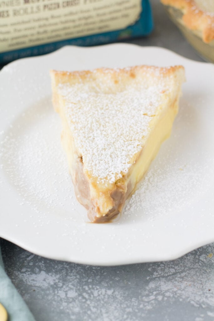 A straight on shot of a slice of Italian Cream Pie on a white plate