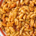 A close up of Homemade Ricotta Cavatelli in a red lined pasta bowl