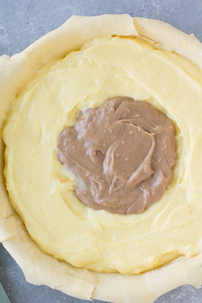 filling for italian cream pie being pulled into the pie plate