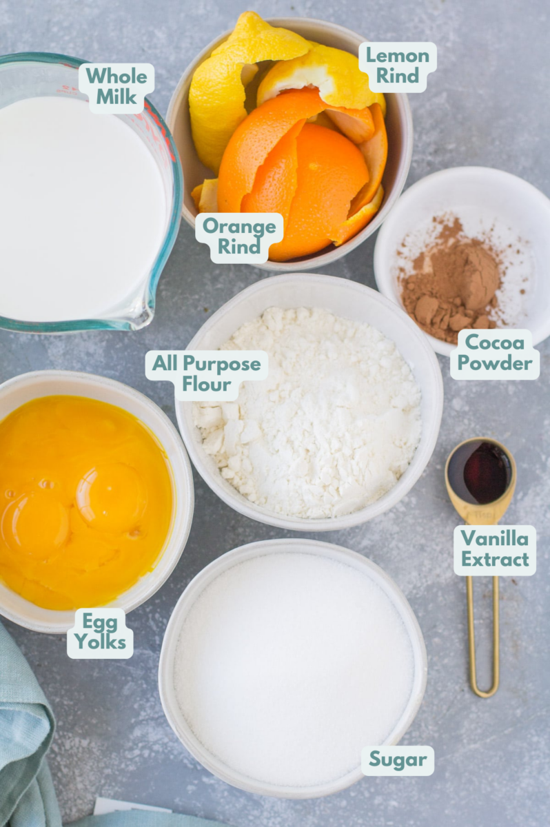 Ingredients for Italian Cream Pie laid out in small white bowls on a grey background.