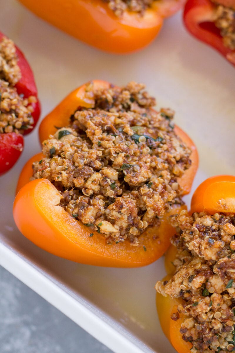 Quinoa stuffing in a bell pepper in a baking dish.