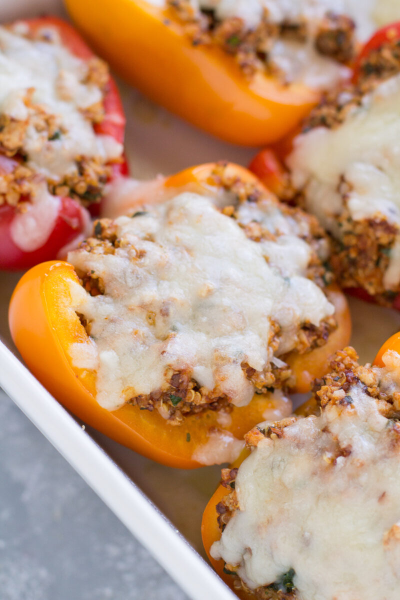 Quinoa stuffed peppers in a baking dish.