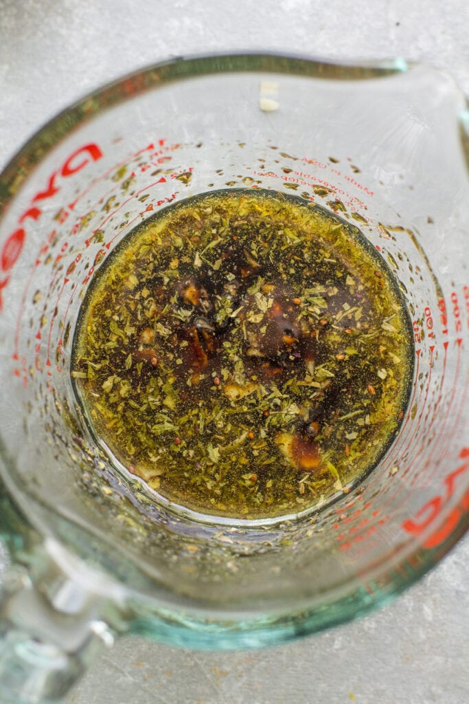 Marinade for balsamic mushrooms being mixed together in a glass measuring cup