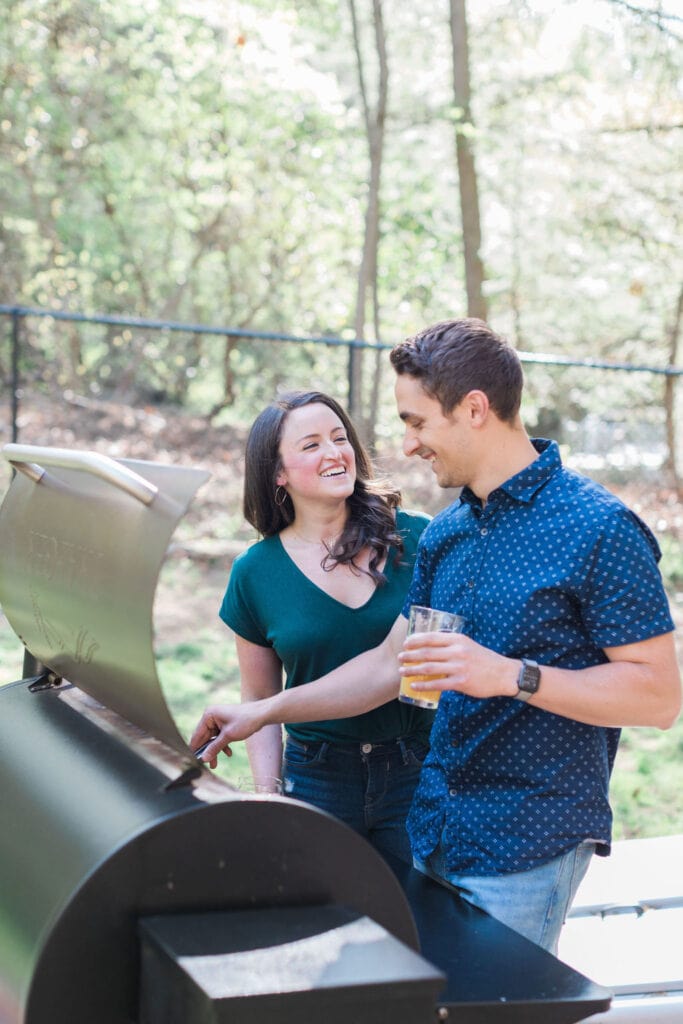 A couple standing at a grill