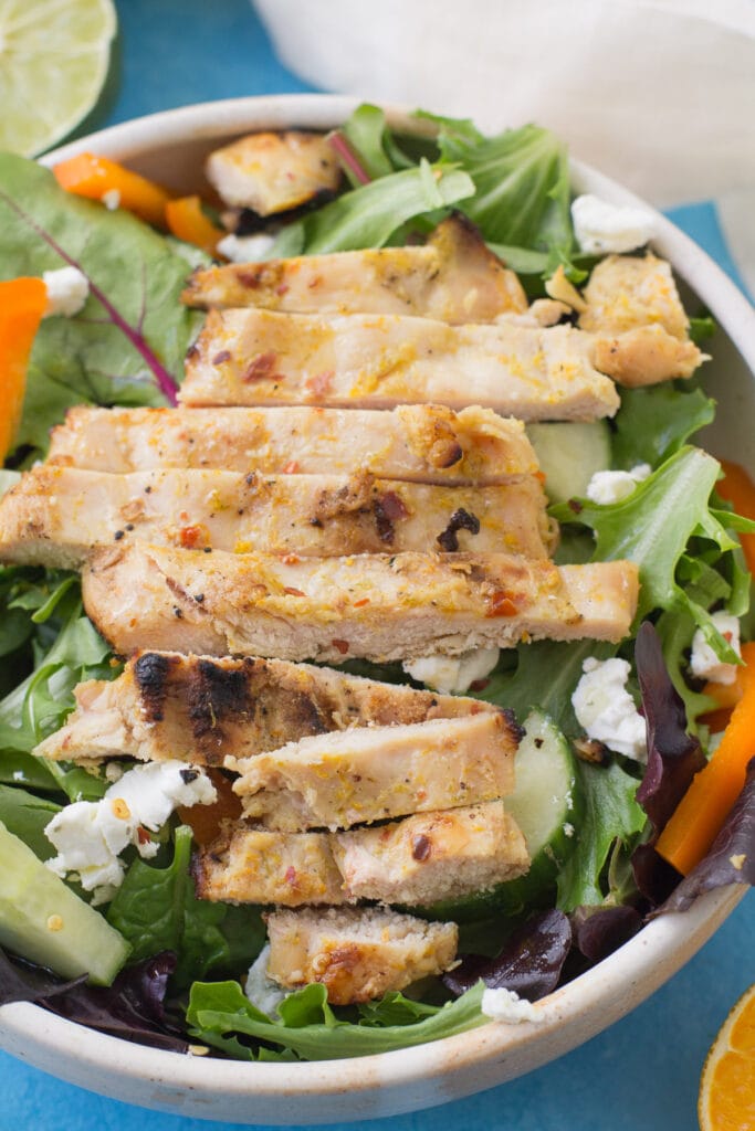 Citrus Grilled Chicken on a salad in a small white bowl