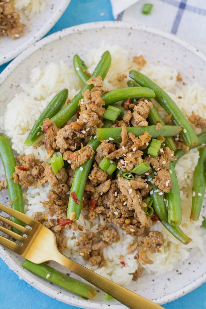 A close up of low carb ground turkey stir fry on a white plate.