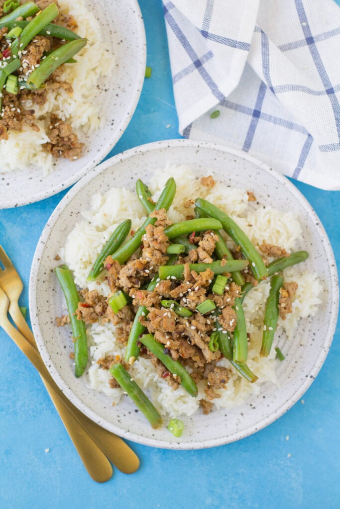 An overhead image looking down at a plate of healthy turkey stir fry on white rice.