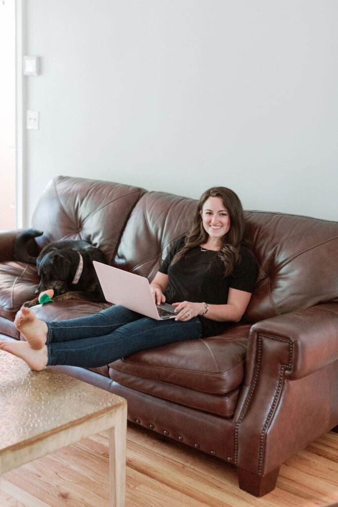 Email Marketing for Food Bloggers - a girl sitting on a couch typing