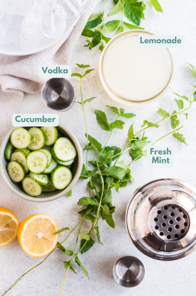 Ingredients for the best cucumber cocktail laid out in small bowls/containers
