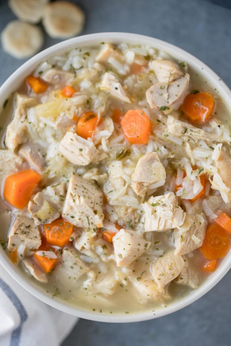 A close up of leftover turkey soup in a grey bowl