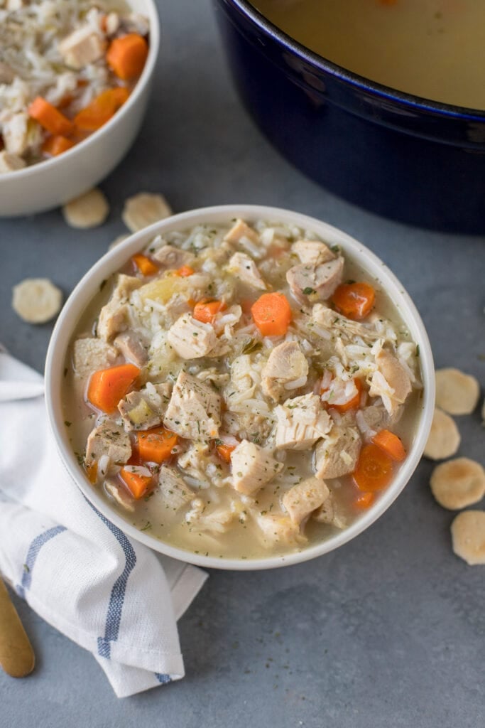 a close up image of a bowl filled with leftover turkey rice soup