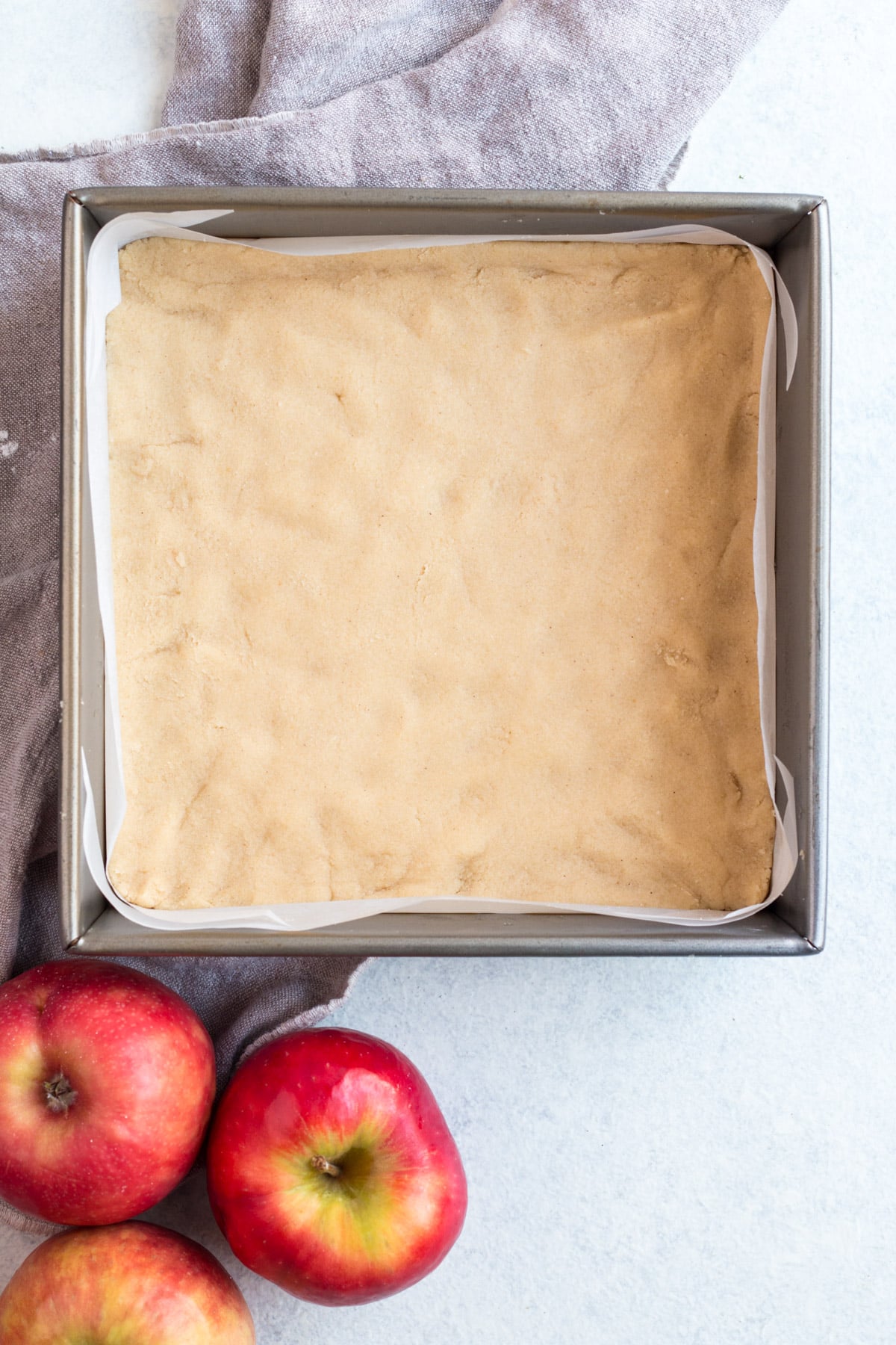 crust of healthy apple pie bars in a metal pan