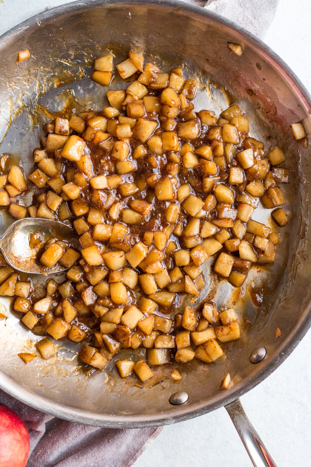 healthy apple crumble bars being sauted in a metal pan